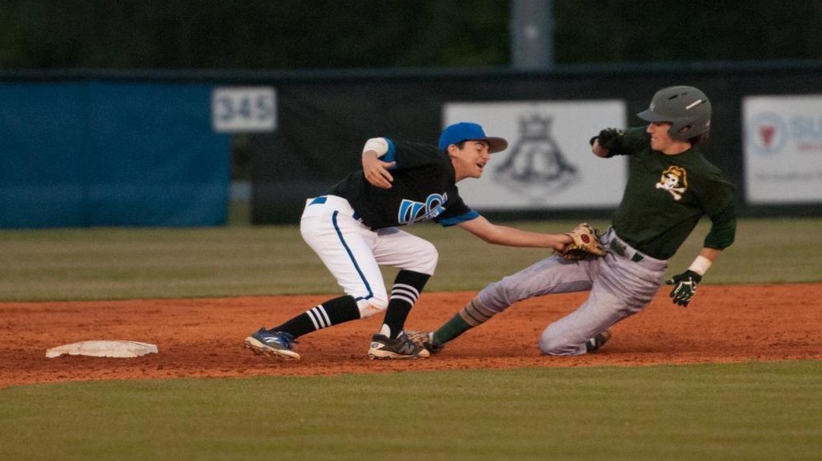 Myrtle Beach’s Jay Morris slides into second, knocking the ball loose as St. James’ Andrew Leo goes for the tag.