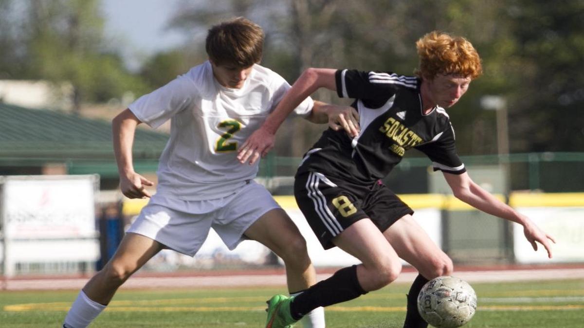Myrtle Beach’s Hunter Harden (left) puts pressure on Socastee’s Cian Gormley during the Soccer at the Beach championship game.