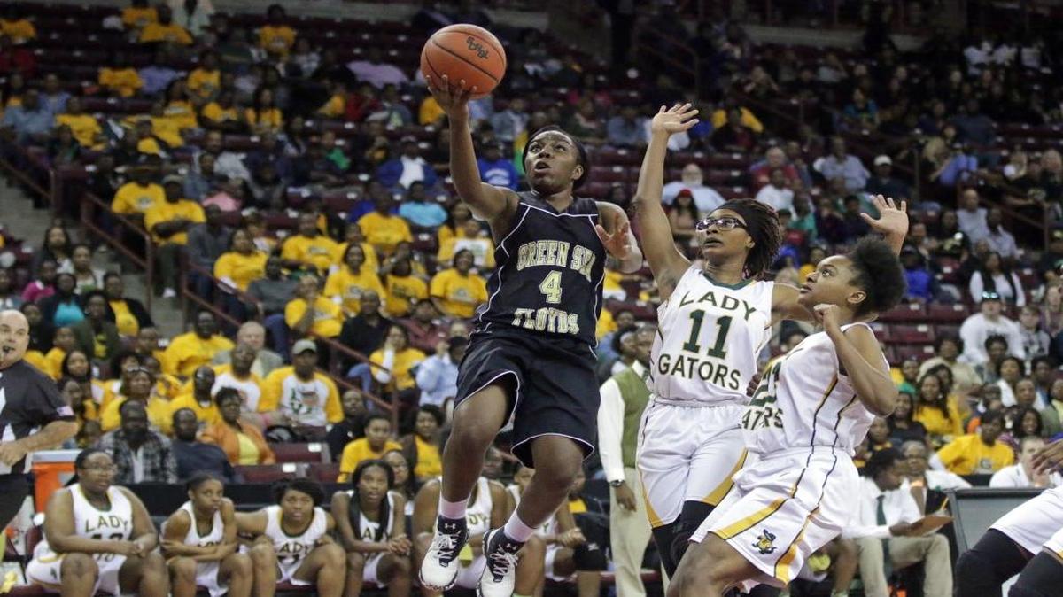 Green Sea Floyds guard Tamara Jackson (4) drives against Estill’s Tykeria Jackson (11) and Jonica Jackson (23) in the Class A girls state championship last month.