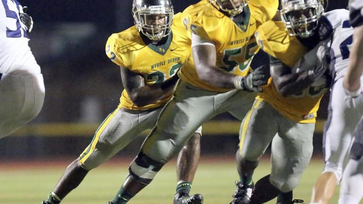 
Myrtle Beach's Brandon Sinclair rushes in the game with Charlotte Christian in the Derrick Law Firm Carolinas Kickoff Clash at Doug Shaw Stadium.
