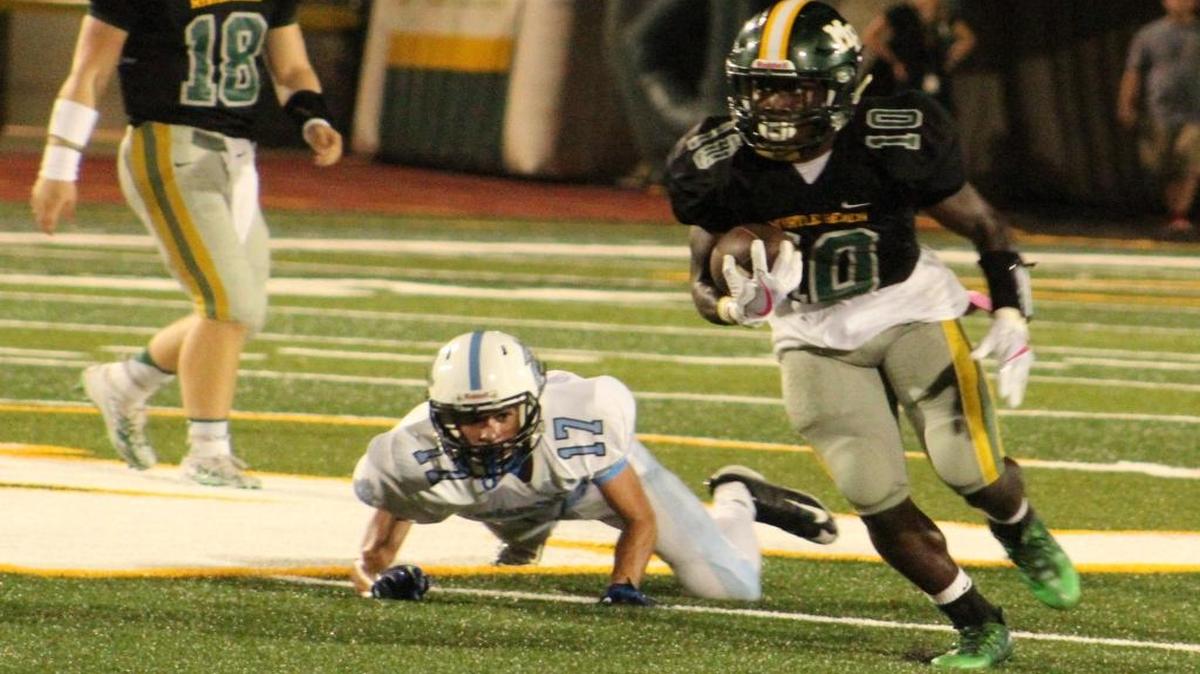 Myrtle Beach running back Jermani Green (10) runs away from St. James' Grant Duvall (17) as Lawson Cribb (18) looks on. Green ran for 144 yards and two touchdowns in the 73-0 victory.