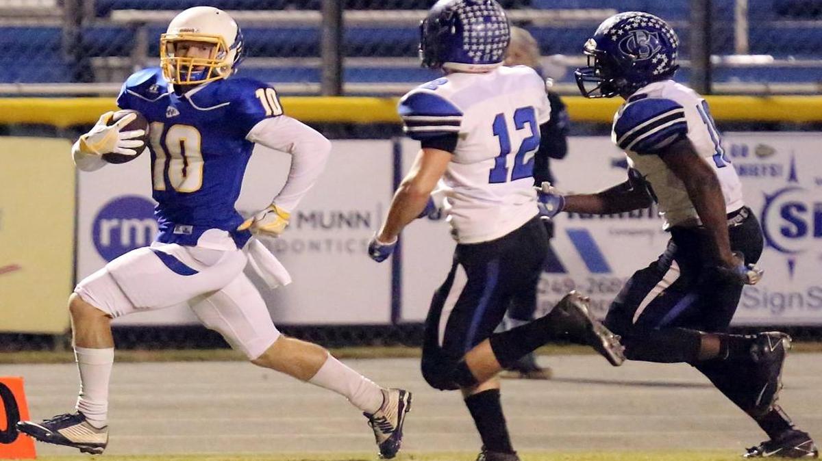 North Myrtle Beach’s Cullin Mitchell (left) skirts the sidelines against Cane Bay on Friday.