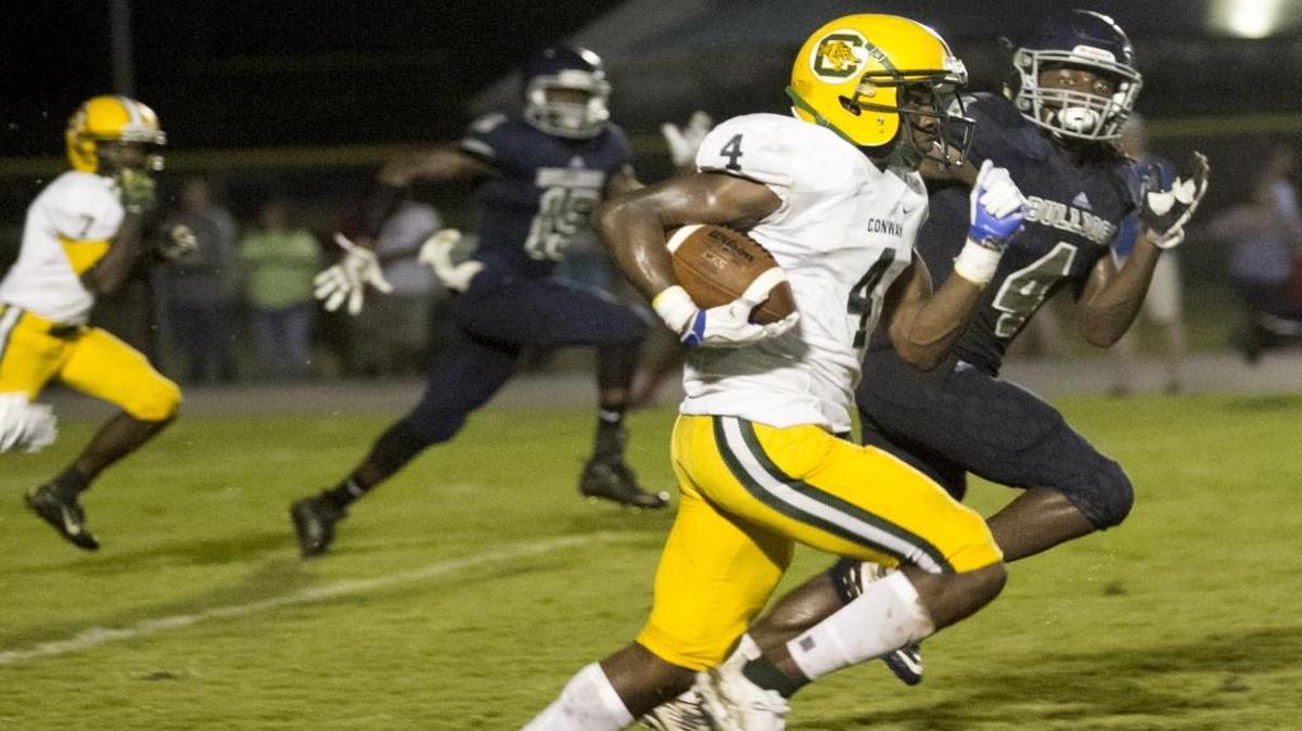 Conway wideout Juwon Moody races past Georgetown tacklers in the Tigers’ season opener. Moody had two touchdown catches Friday in Conway’s win over Wilson.
