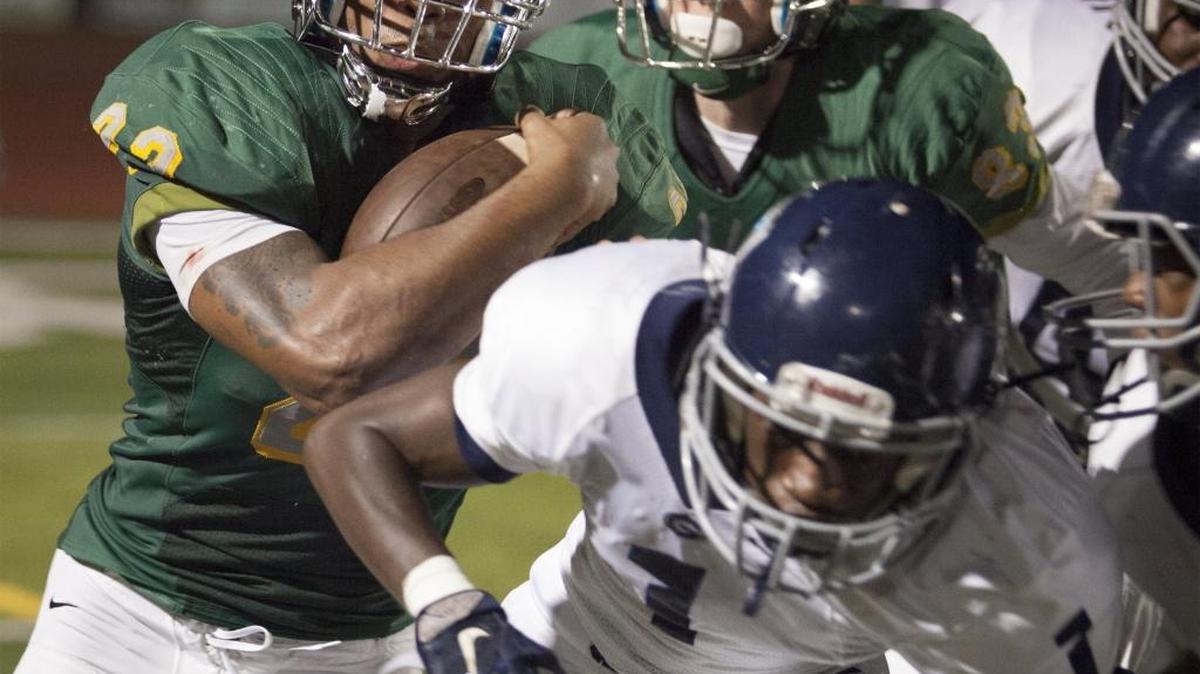 Myrtle Beach running back Brandon Sinclair (22) tries to get past Georgetown defenders Friday.