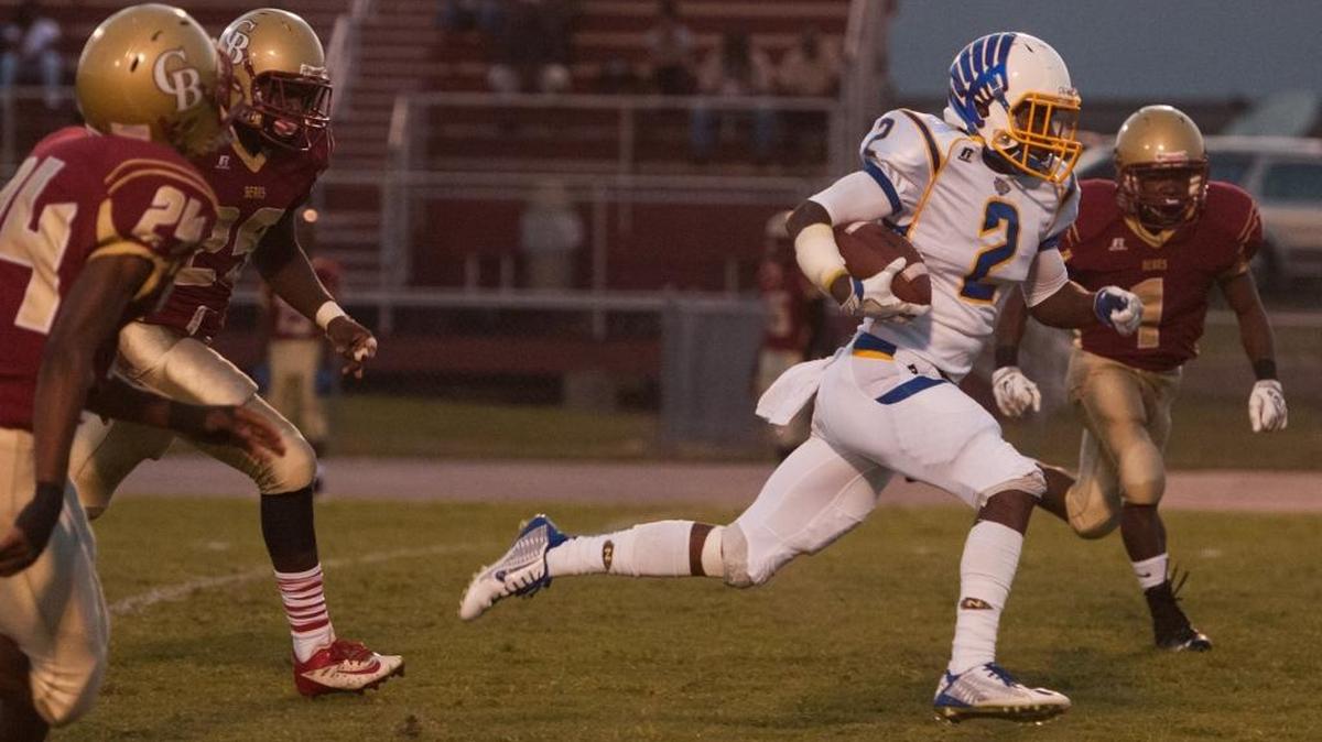 North Myrtle Beach’s Tyler Gore runs with Carvers Bay defenders in pursuit Friday.