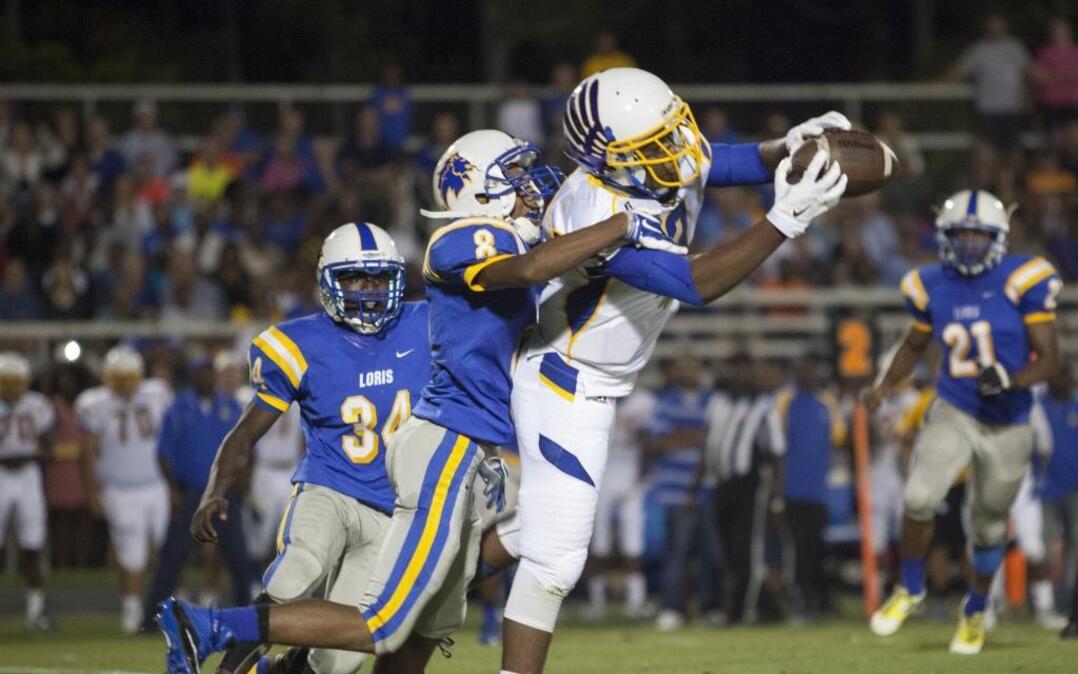 
North Myrtle Beach wide receiver Merrill Moss (3) makes a tough catch against Loris defender Hakeem Jackson during the second quarter.
