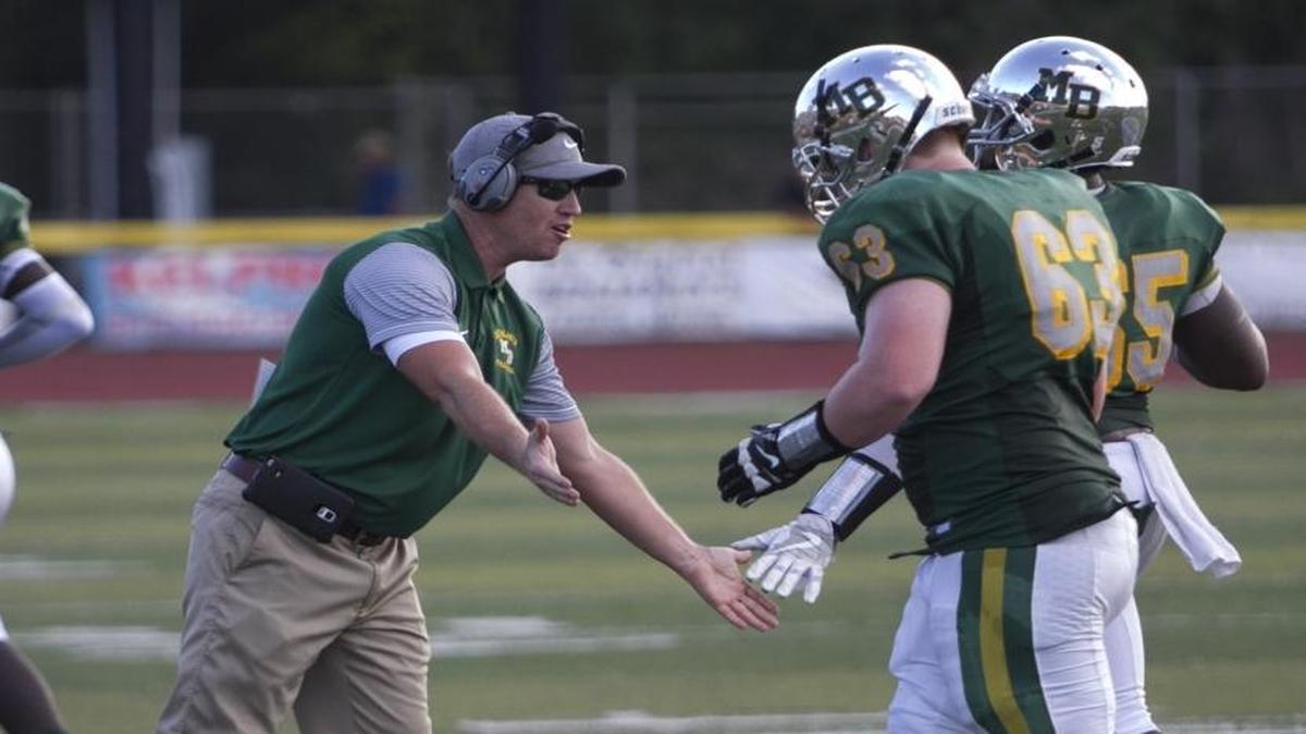 Myrtle Beach coach Mickey Wilson congratulates his team following a big play during a recent game.