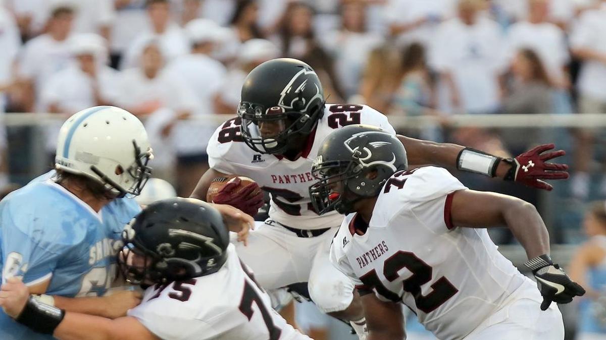 Carolina Forest’s Dyverse Simmons leaps over the line during Thursday’s game against St. James.