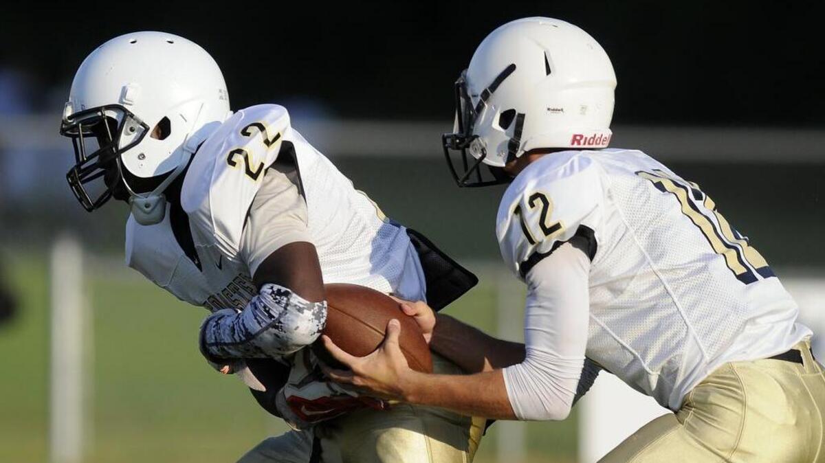
Socastee quarterback Brandon Goswick (right) fakes a handoff to running back Malachi McClendon during a game against Waccamaw in the CNB Kickoff Classic.
