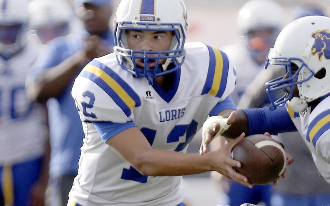 
Loris quarterback Ta’Jay Williams fakes a handoff during the Lions’ scrimmage against Myrtle Beach on Friday at Doug Shaw Stadium.

