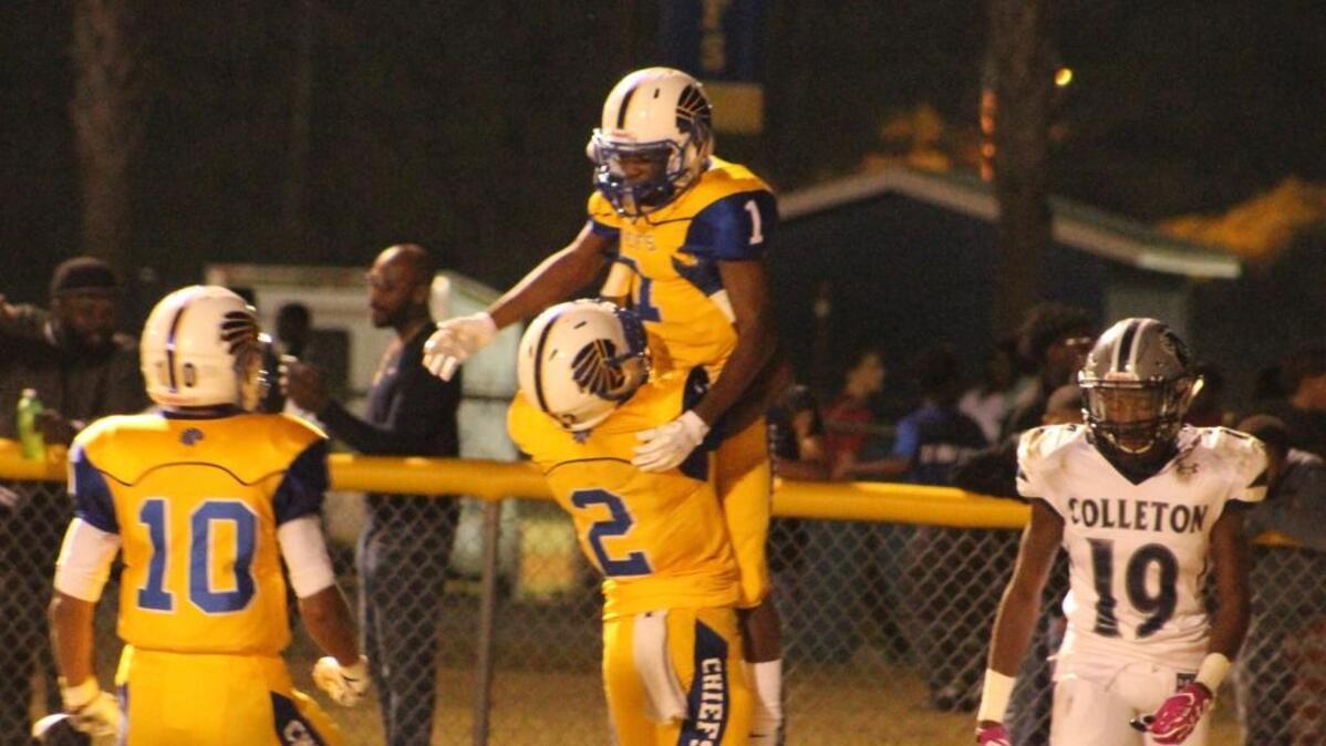 Celebrating a touchdown catch by Derion Conyers (1) are North Myrtle Beach players Tyler Gore (2) and Tyron Stockdale (10) as Colleton County's Devin Kinsey (19) walks toward his sideline.