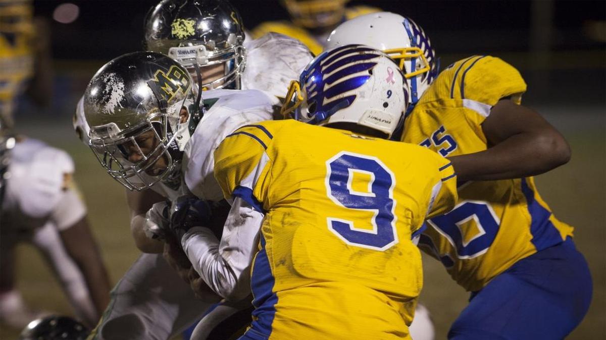 Myrtle Beach running back Brandon Sinclair (center) busts through the North Myrtle Beach defense for a first down.