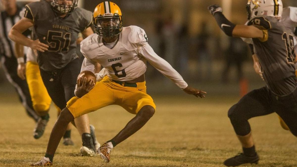 Conway quarterback D’Wuan Grainger makes a move in an effort to elude a Socastee tackler during a game earlier this season.