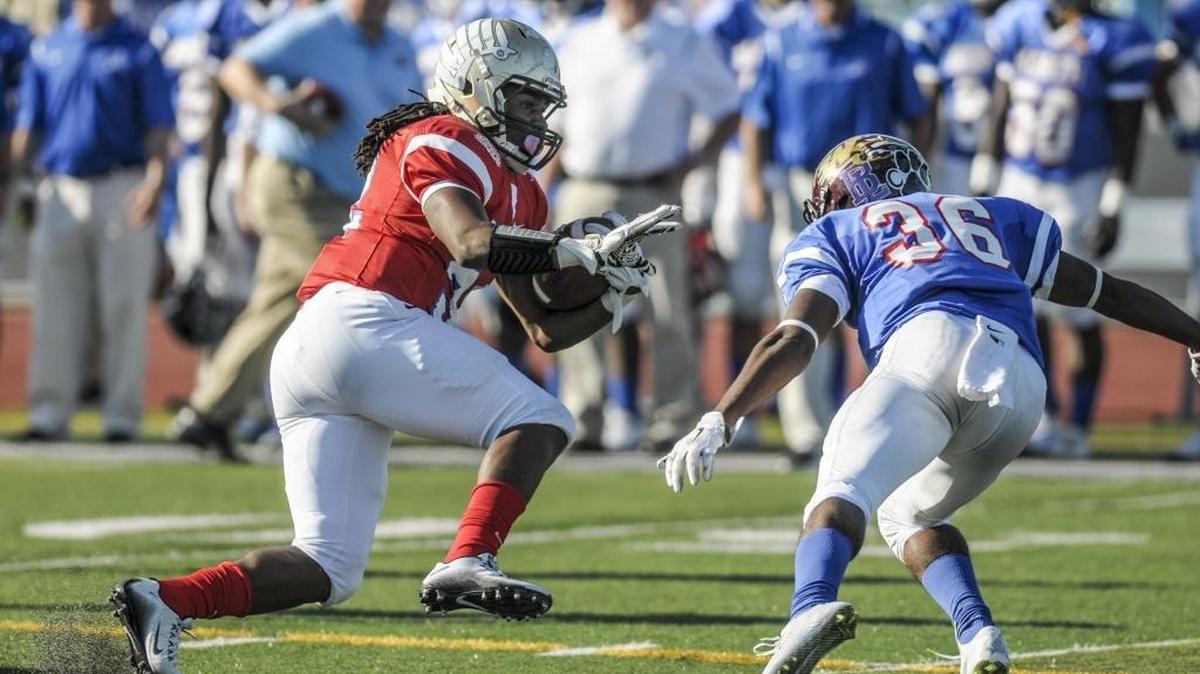 Conway's Jah'Maine Martin dodges a tackle from Woodruff's Qua Phelps during the Touchstone Energy Bowl - North vs. South All-Star Game.