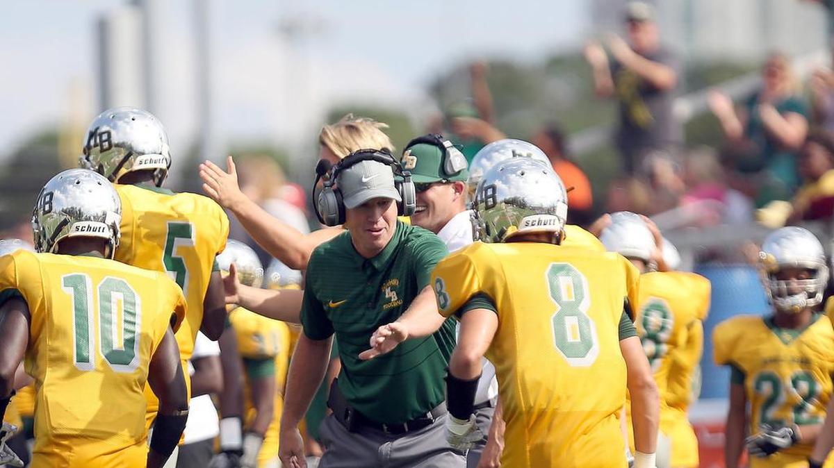 Myrtle Beach coach Mickey Wilson celebrates a touchdown in a game with Charlotte Christian Academy on Aug. 25, 2017.