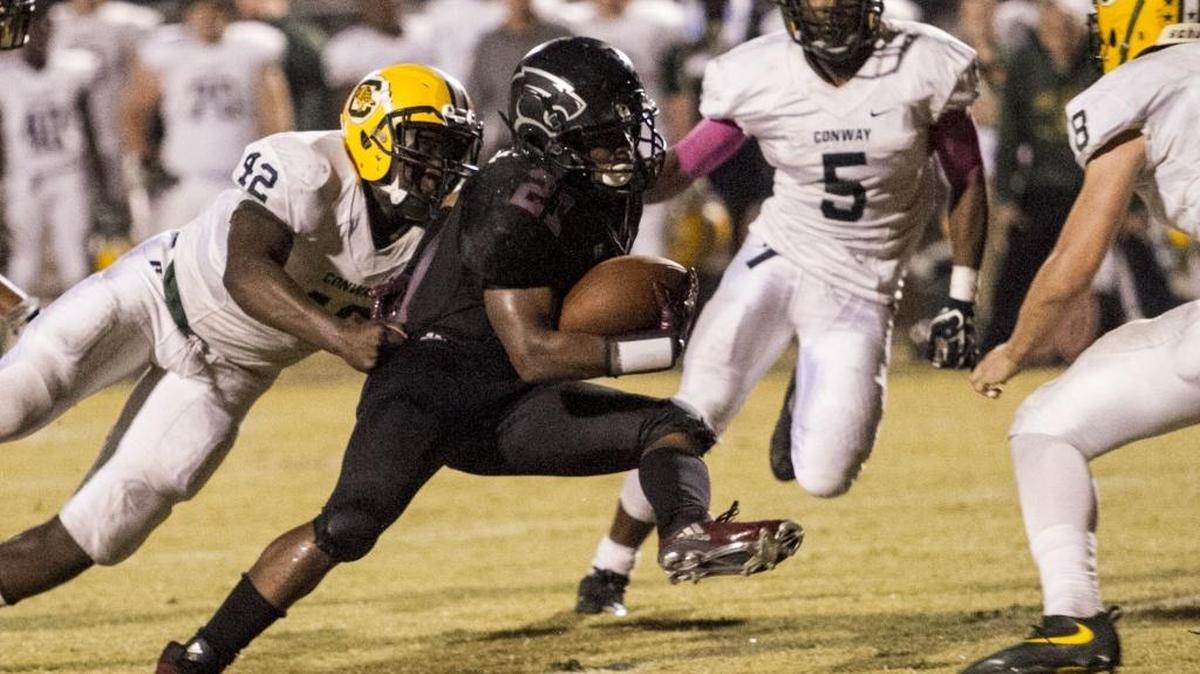 Carolina Forest’s Anthony McAfee looks for running room against Conway earlier this season.