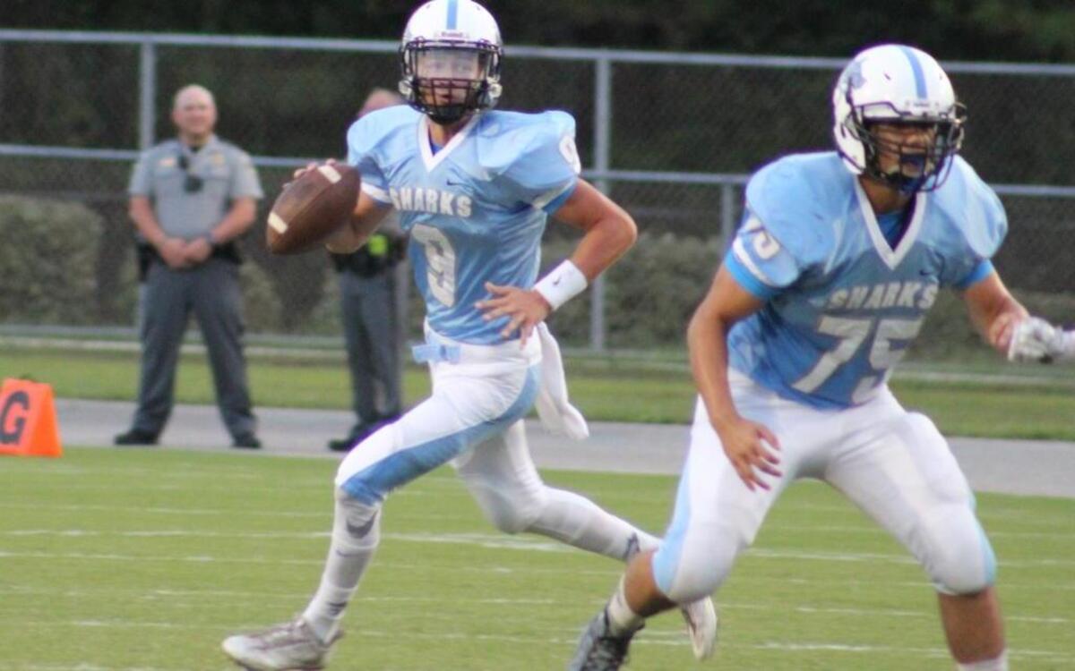 Berkeley Young (9) rolls out of the pocket to extend a play for St. James as teammate Alex Cardoza (75) blocks a Waccamaw defender.