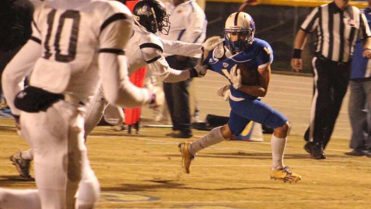 North Myrtle Beach running back Kered Class (4) fights off a tackle attempt by Crestwood's Jalen Owens (4) as safety Joshua Simon (10) looks on. Class would run for 120 yards and three touchdowns to lead the Chiefs to victory.