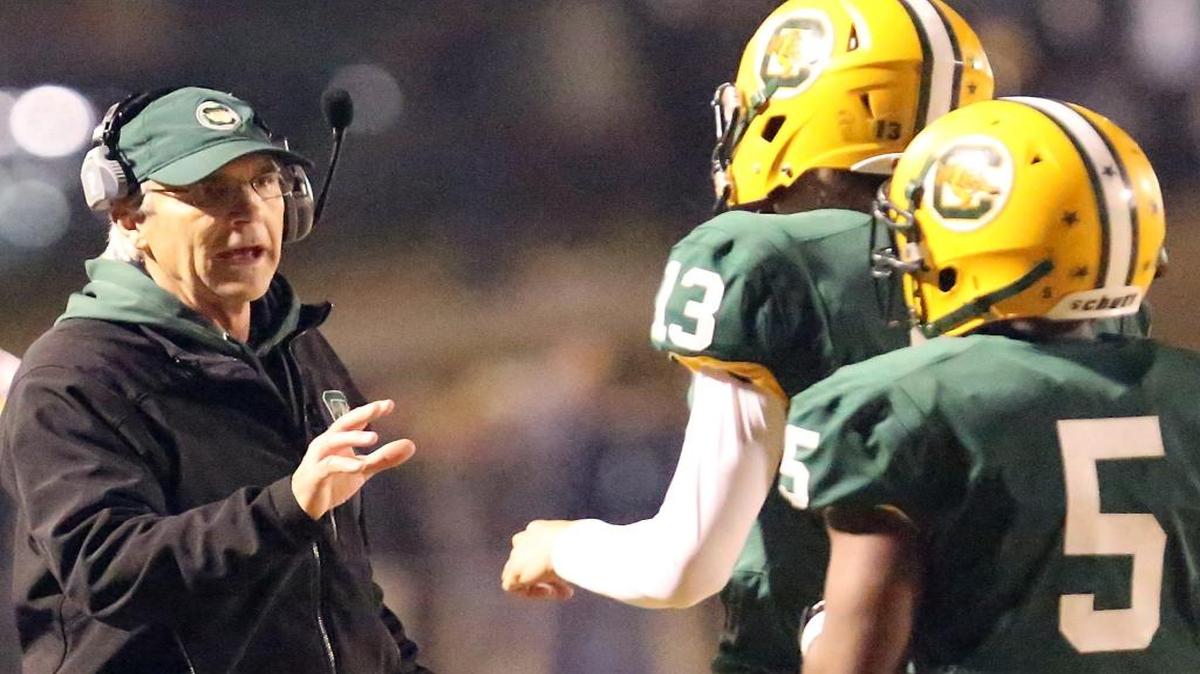 Conway football coach Chuck Jordan talks with players during his team’s playoff matchup last November. With his case unresolved, the program named an interim to serve in his stead.