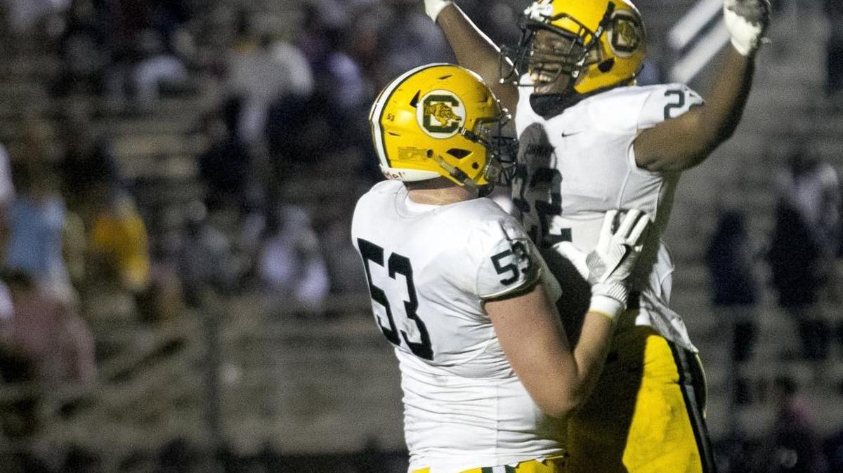 Conway running back Antonio Long jumps into the arms of offensive lineman Gunner Britton after scoring a touchdown during the Tigers’ 40-8 win over Georgetown.
