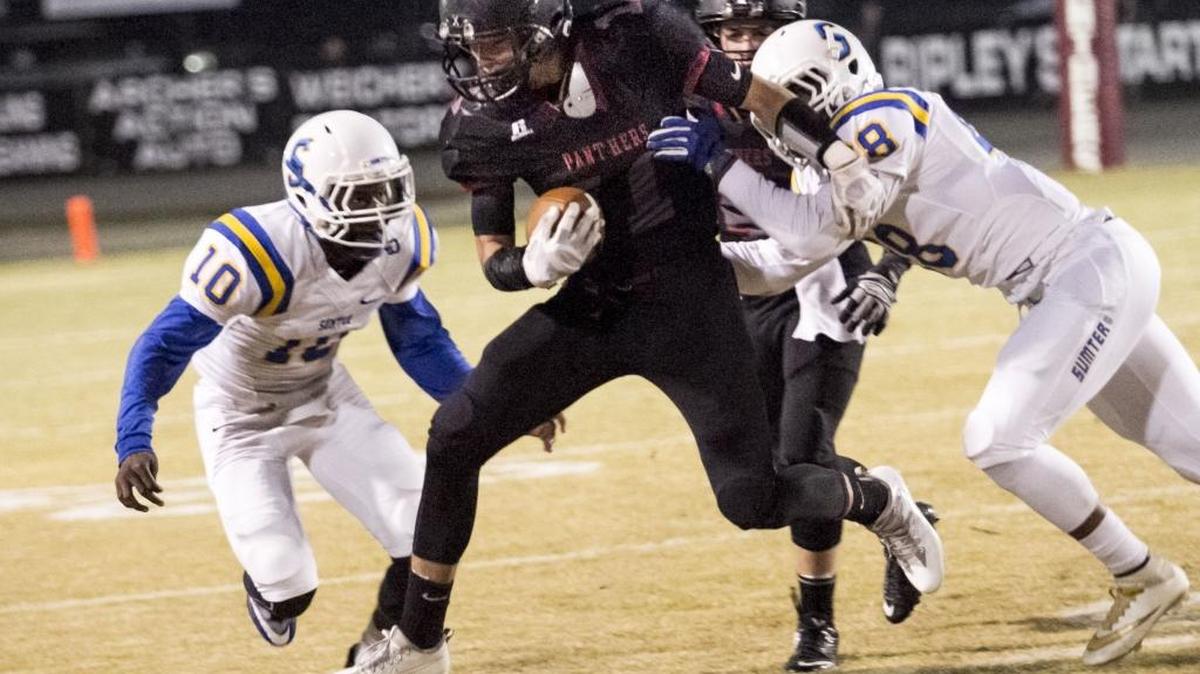 Carolina Forest’s Ismael Garcia (center) looks to avoid Sumter defenders Friday night.
