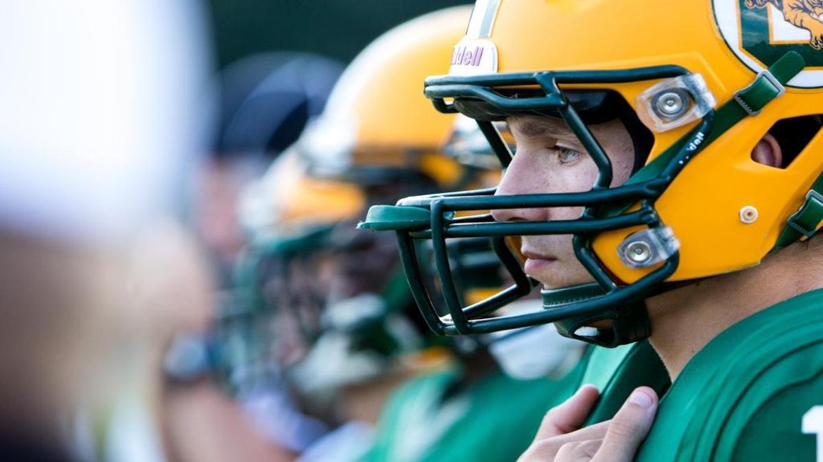 Senior quarterback Peyton Derrick gets instructions before last week’s game against Georgetown.