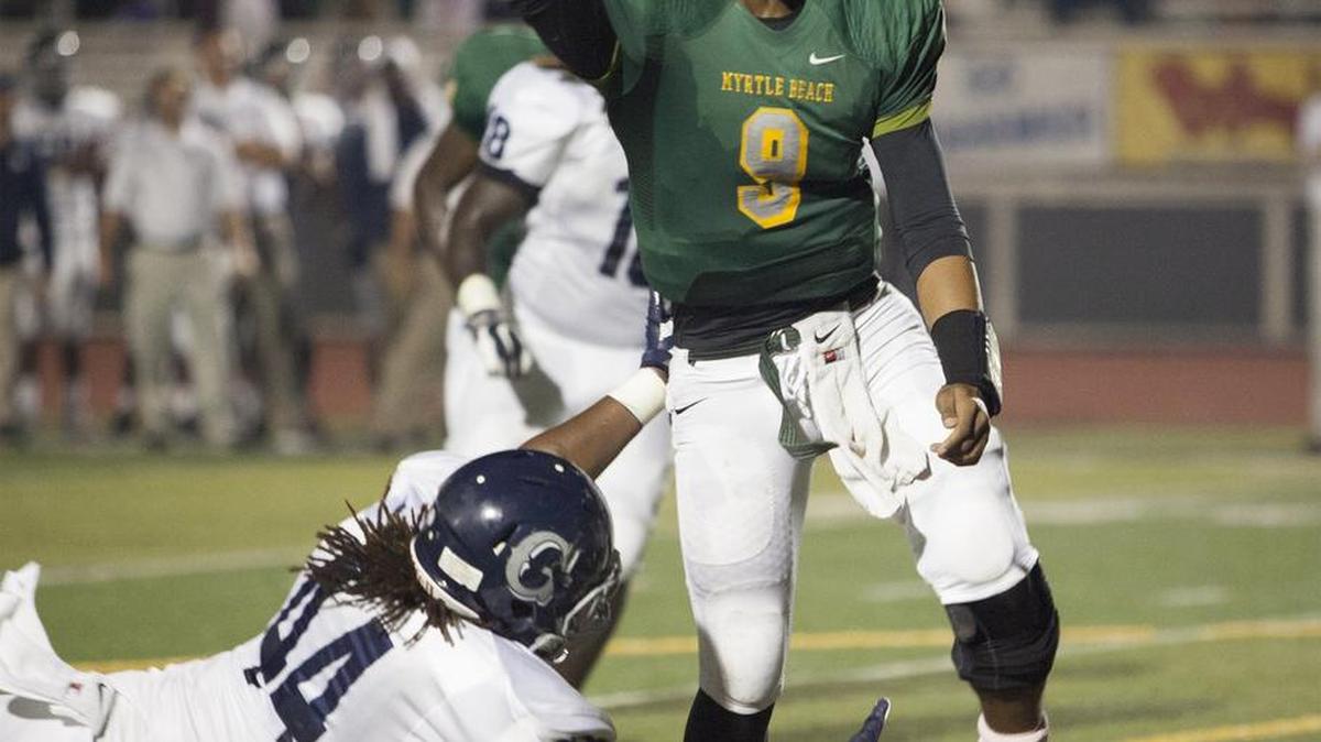 Myrtle Beach quarterback Drayton Arnold (9) just gets a pass off before a tackle attempt by Georgetown's Sheldon Billings (44) as the Seahawks hosted Georgetown Friday night at Doug Shaw Stadium.