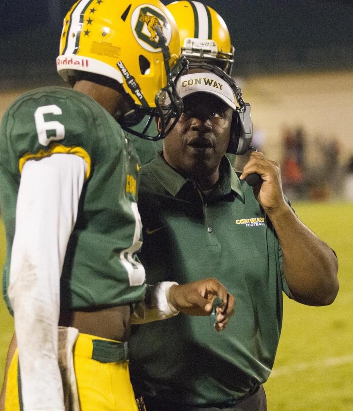 Conway interim football coach Carlton Terry talks with quarterback Darren Grainger during a game this past season.