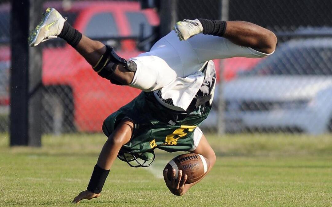 
Myrtle Beach quarterback Drayton Arnold cartwheels across the field after being hit by an Aynor defender during their CNB Kickoff Classic.

