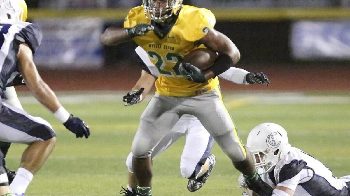 
Myrtle Beach’s Brandon Sinclair gets away from a few Charlotte Christian defenders during Friday night’s game.
