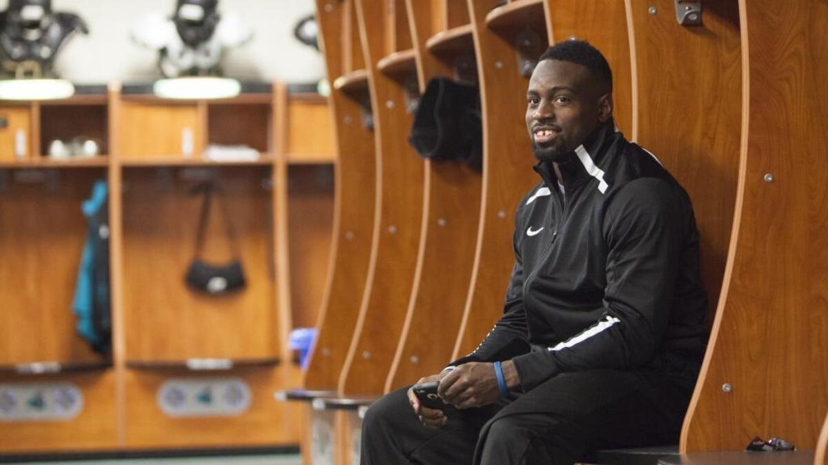 Coastal Carolina great Quinn Backus sits in the Chanticleers’ locker room a few years ago. He now can be found on the gridiron, albeit in a coaching role at Myrtle Beach High School.
