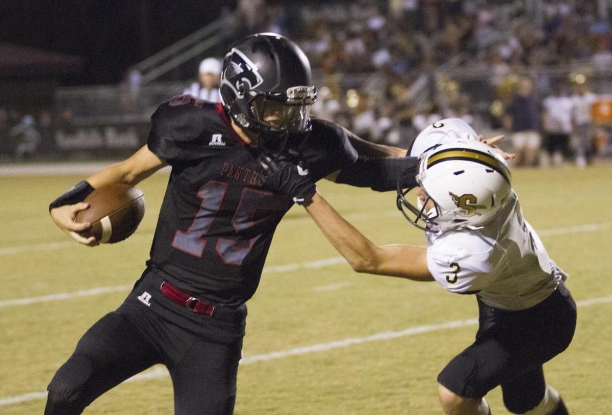 Carolina Forest quarterback Matt Beale delivers a stiff arm to a Socastee tackler last Friday night.