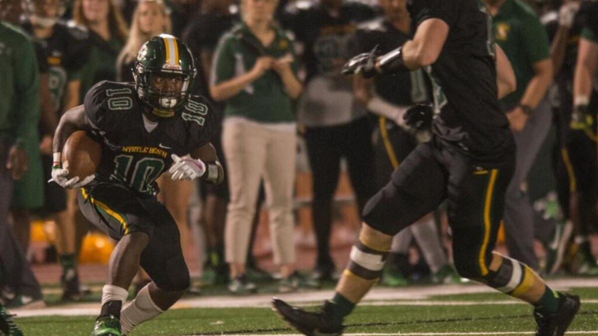 Myrtle Beach running back Jermani Green surveys the field in search of room to run during Friday’s playoff game against Beaufort.