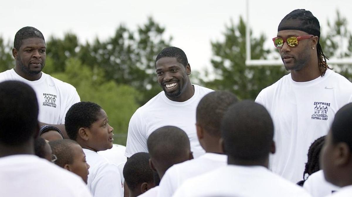 Clifton Geathers, Robert Geathers Jr. and their friend Mike Johnson speak to children about life lessons during a camp a few years ago at Carvers Bay High School.