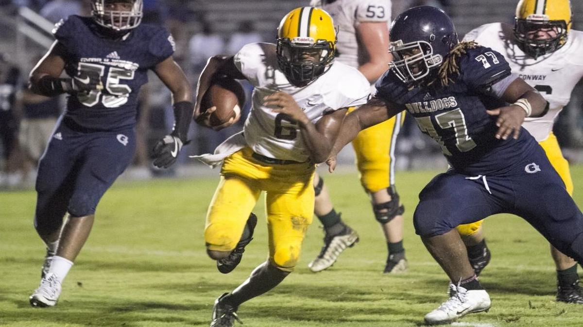 Conway quarterback D'Wuan Grainger threads through the Georgetown defense during last Friday night’s game.
