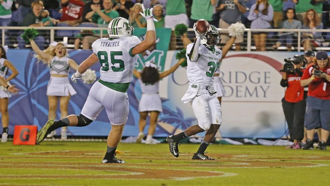 Marshall’s Rakeem Cato with teammate and former Carolina Forest standout Ryan Yurachek (85) in the 2014 Boca Raton Bowl.