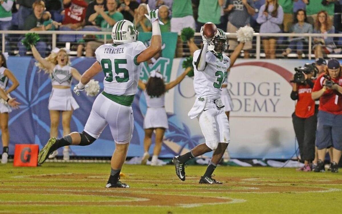 Marshall’s Rakeem Cato with teammate and former Carolina Forest standout Ryan Yurachek (85) in the 2014 Boca Raton Bowl.