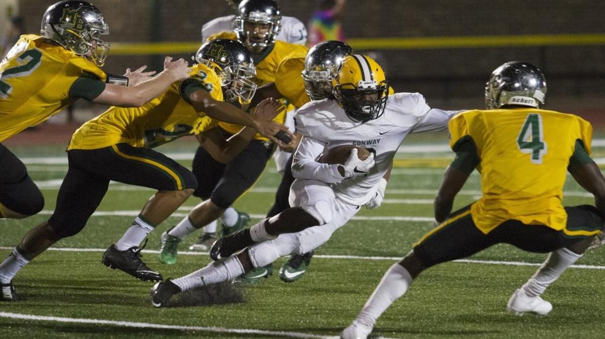 Myrtle Beach tacklers swarm around Conway’s Rakim Bellamy during Thursday’s Battle for the Victory Bell at Doug Shaw Memorial Stadium.