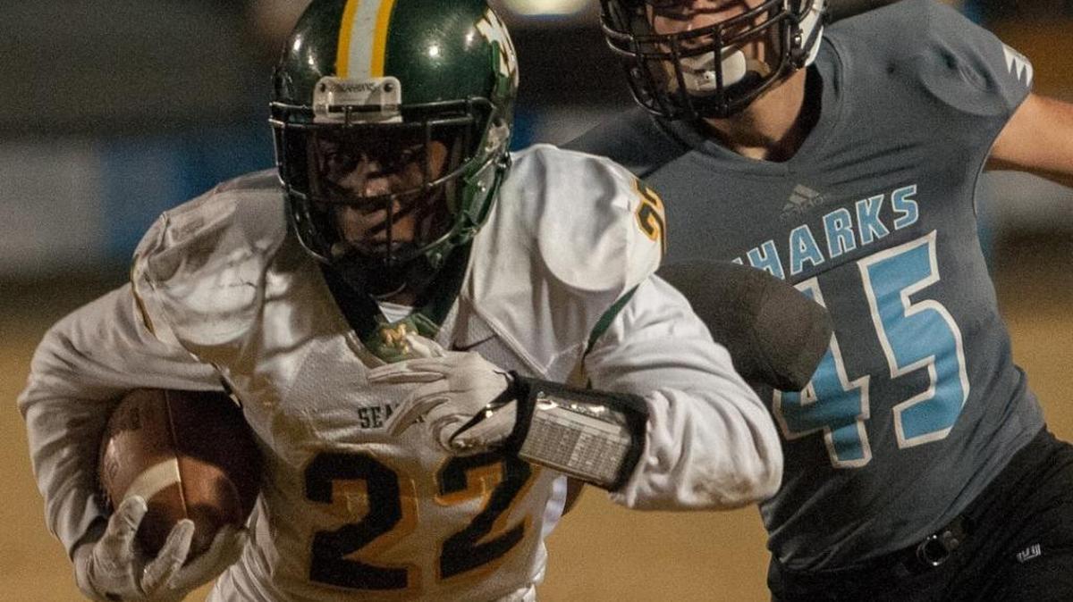 Myrtle Beach’s Jermani Green (left) tries to run through a St. James tackle Friday.