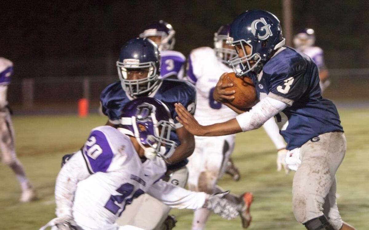 Georgetown quarterback Jarvis Brown looks to elude Darlington defenders Friday.