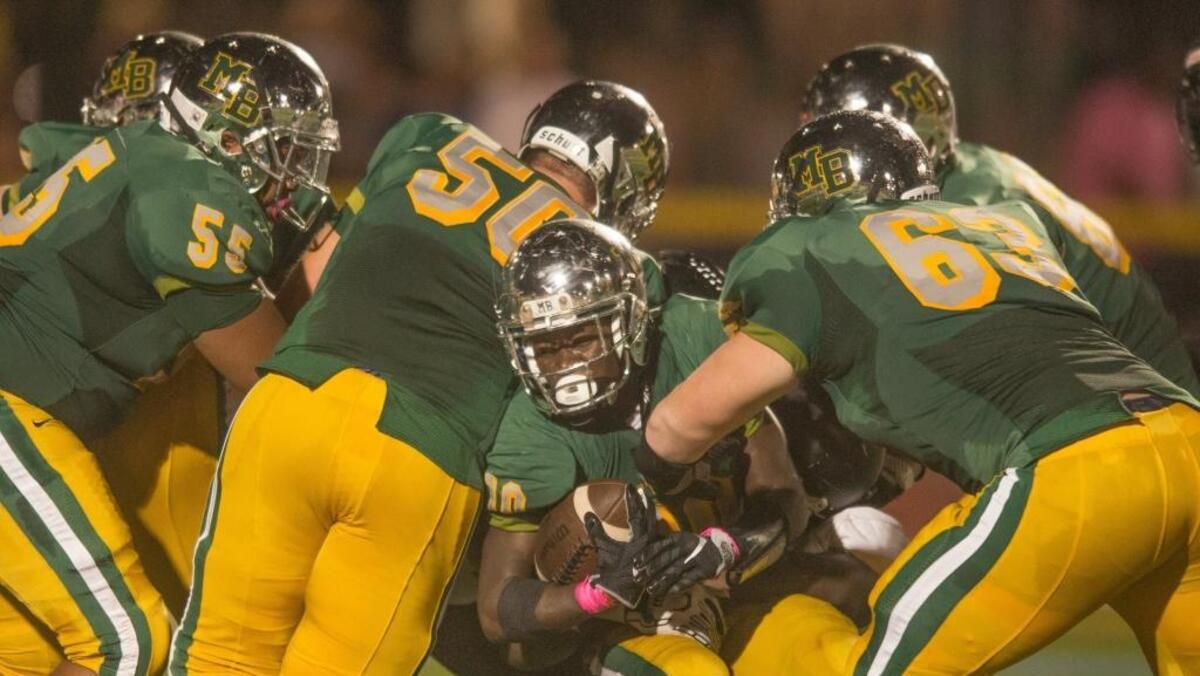 Myrtle Beach offensive lineman offer running back Jermani Green some assistance during last Friday night’s game against Marlboro County at Doug Shaw Memorial Stadium.