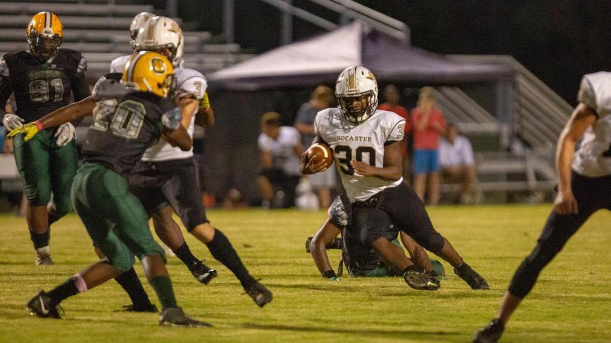 Socastee Braves sophomore running back Christian Inman runs the ball against the Conway Tigers defense Saturday night in Conway. Both teams are expected to be back in action Friday.