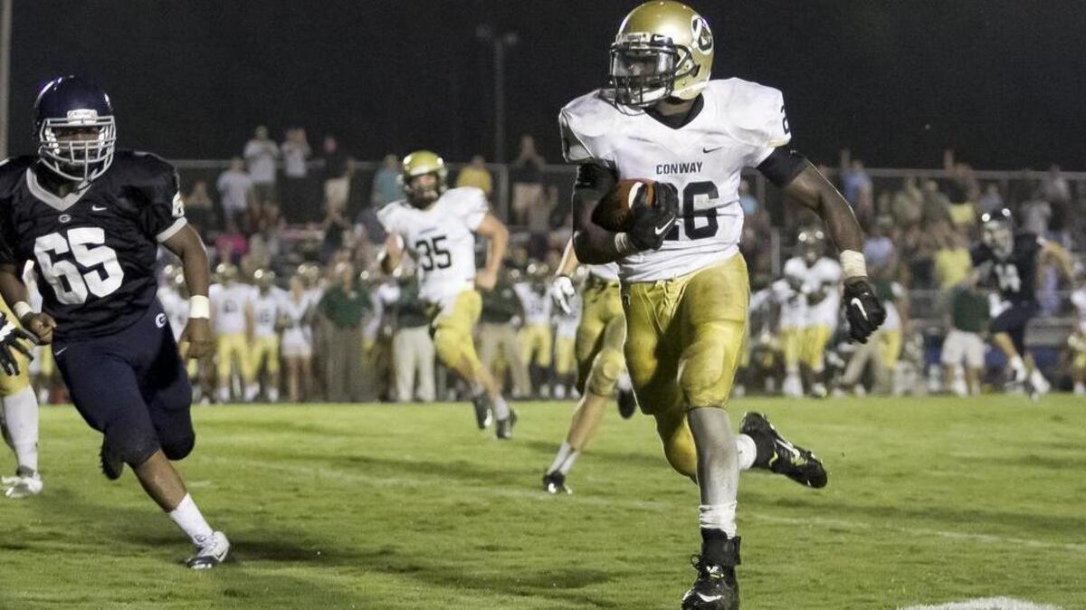 
Conway’s Jerron Bellamy runs back an interception to set the Tigers up for their first touchdown against Georgetown on Friday.
