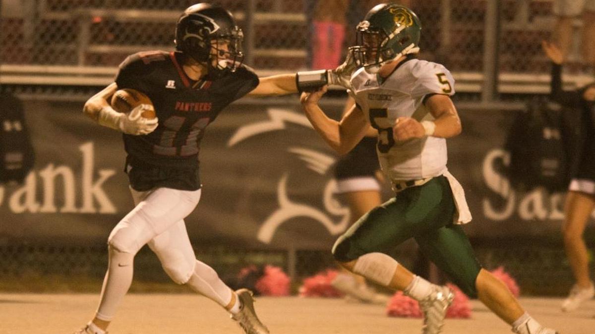 Carolina Forest wideout Jackson Weaterwax stiff arms a West Florence tackler on the way to the end zone Friday night.