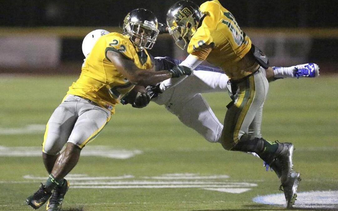
Myrtle Beach’s Brandon Sinclair (22) gets a block from teammate Jermani Green (40) during Saturday’s game against Charlotte Christian (N.C.) in the Derrick Law Firm Carolinas Kickoff Clash.
