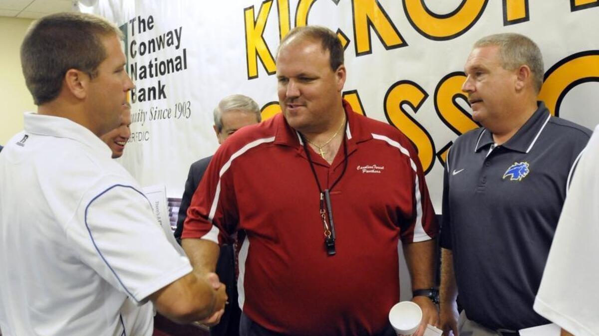 Carolina Forest head coach Marc Morris (center) speaks with several area coaches during last year’s CNB Kickoff Classic press conference. The Panthers head man was named Palmetto Champions Lower State 5A Coach of the Year on Sunday.