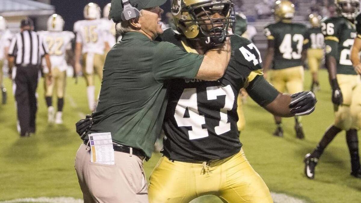 
Conway’s Zuri Phifer gets a congratulatory hug from coach Chuck Jordan after making a big tackle against Socastee.
