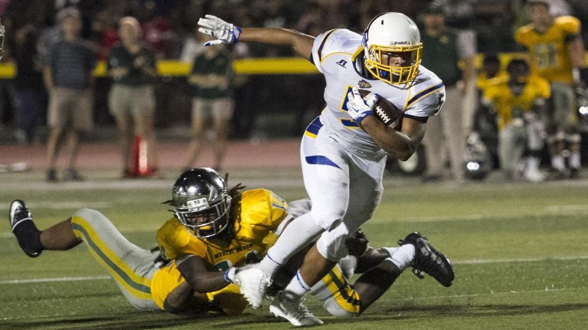 North Myrtle Beach’s T.J. Gore shakes off Myrtle Beach defenders.