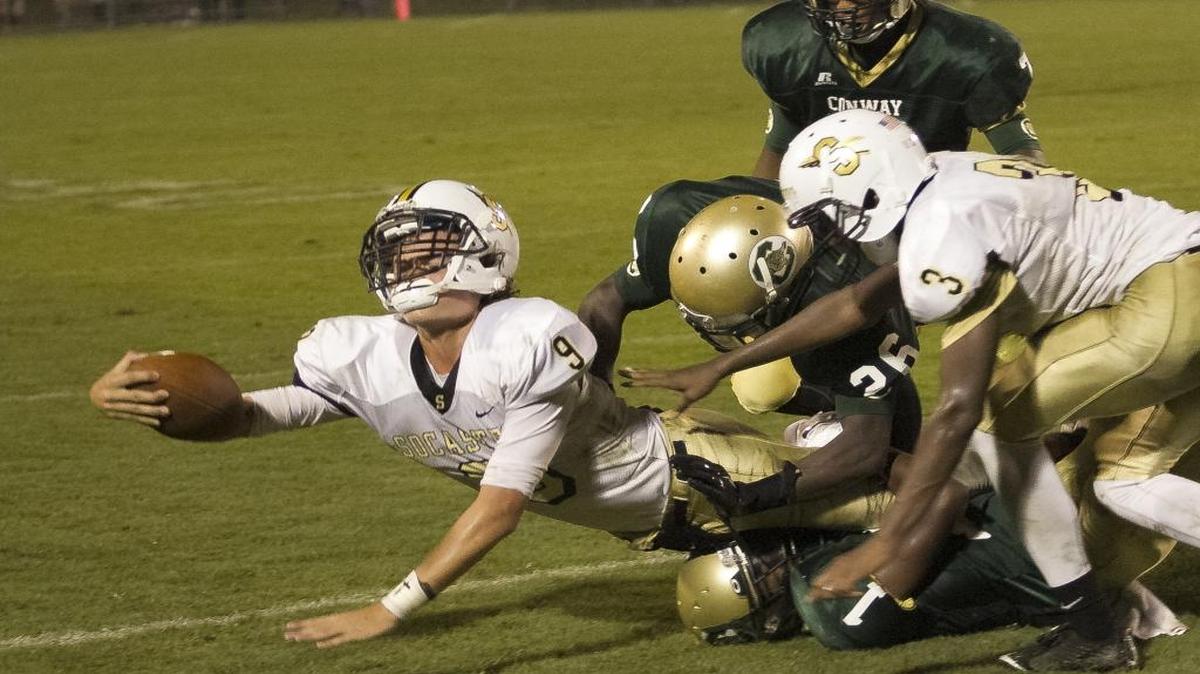 
Socastee’s Hunter Illing (left) lunges forward during a game against Conway earlier this year.
