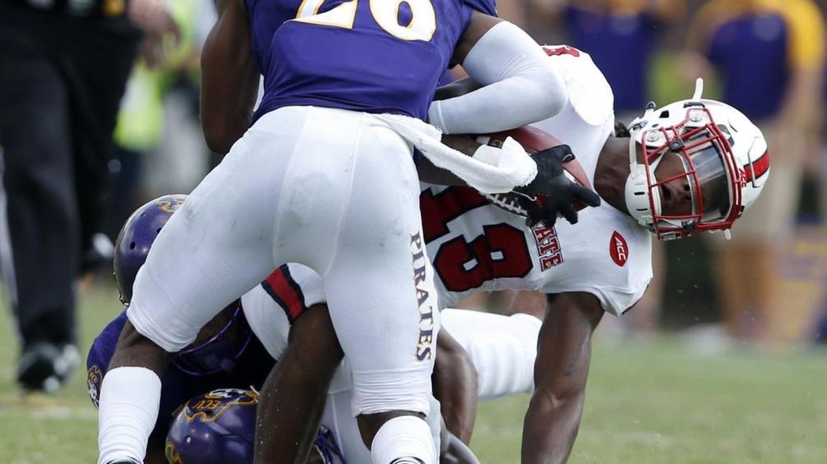 Former North Myrtle Beach standout Colby Gore and other East Carolina tacklers chip in to bring down a N.C. State ball carrier earlier this season.